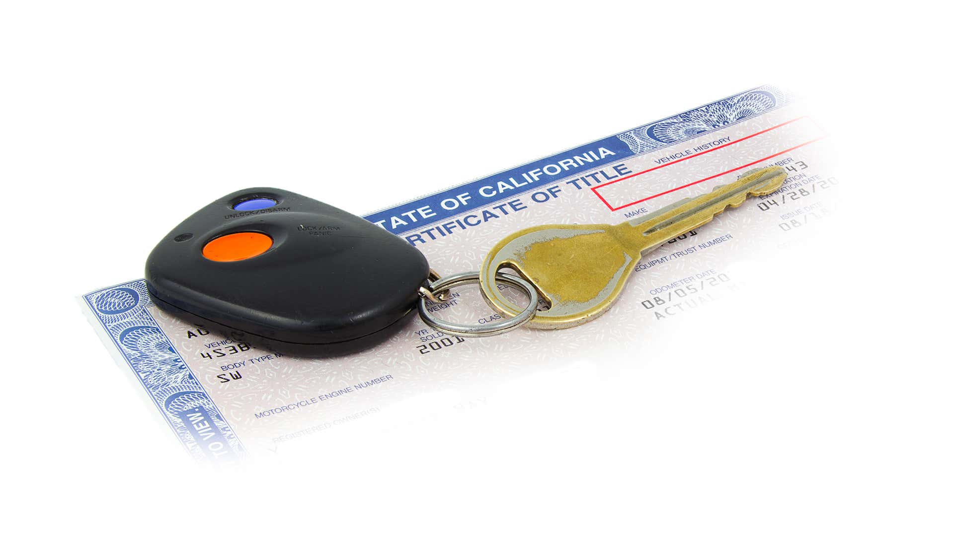 A set of keys sits on a car title. 汽车所有权上有一串钥匙。