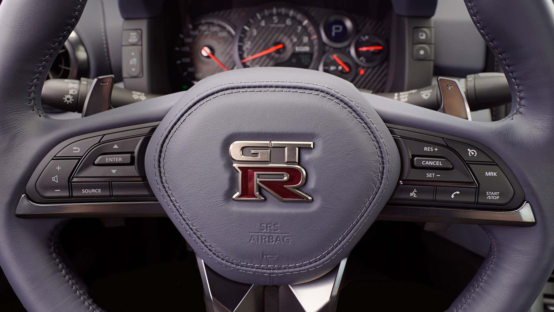 The steering wheel of a Nissan GT-R with paddle shifters. 日产GT-R带拨杆换档器的方向盘。