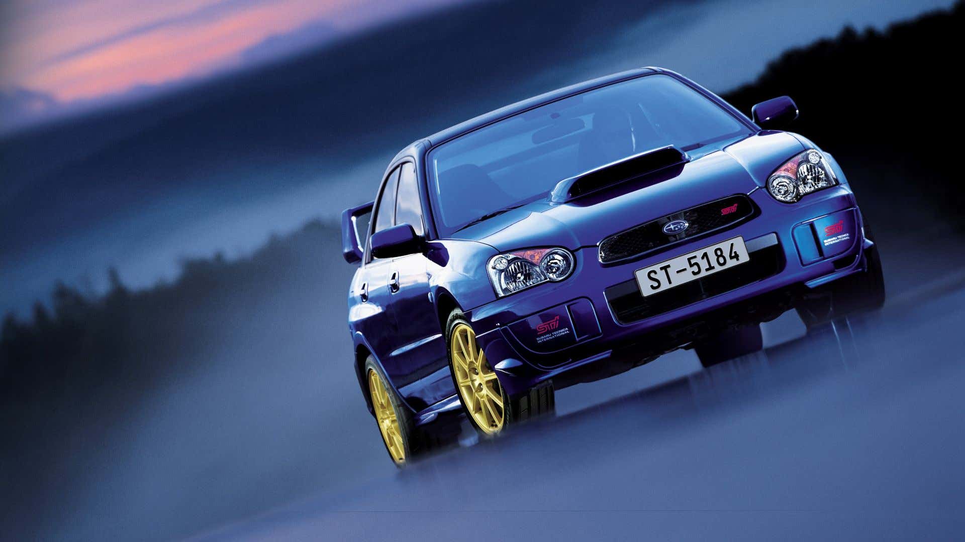 A blue Subaru WRX STI poses with gold wheels. 蓝色底座wrx sti与金轮姿势。