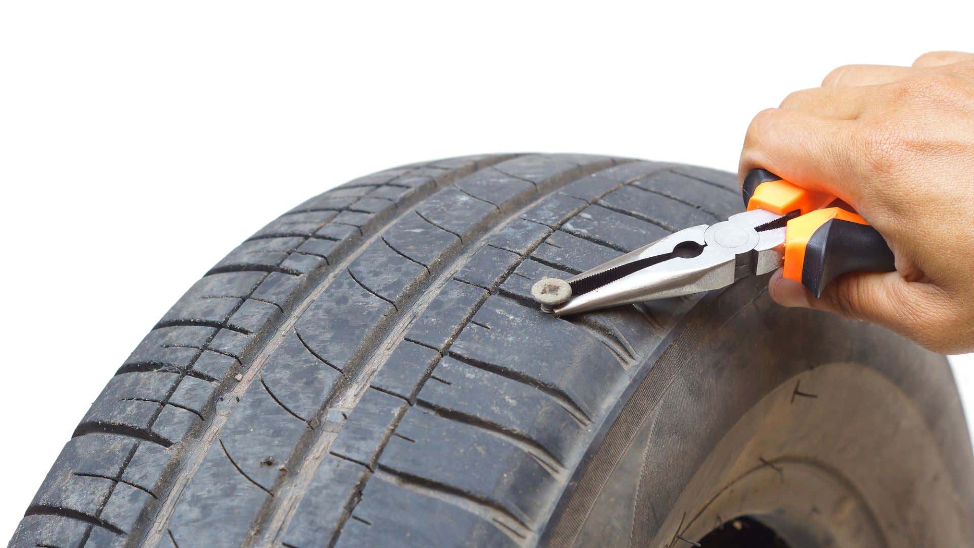 A screw in a tire. 轮胎上的螺丝钉