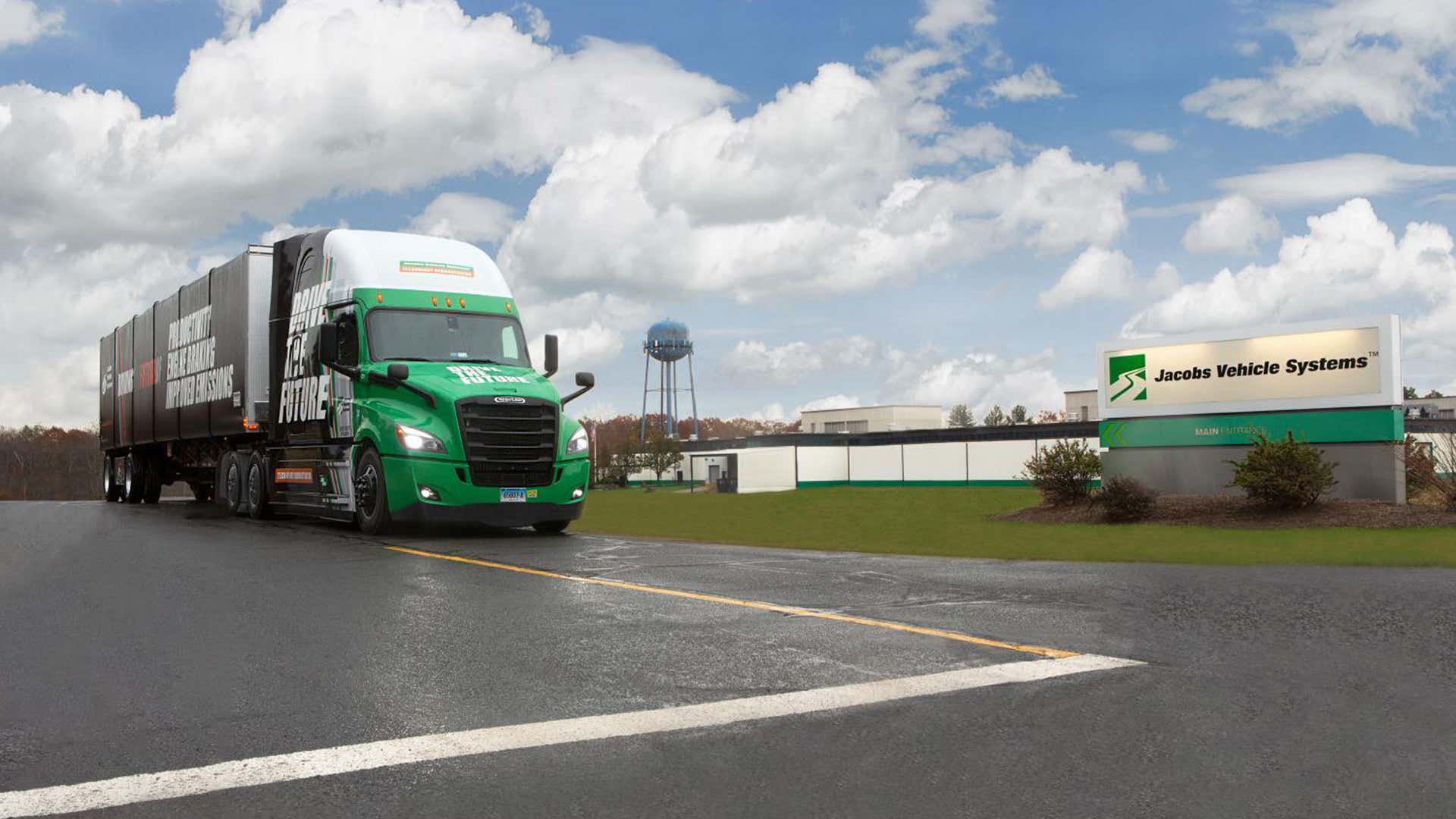 A truck with a Jake Brake in front of Jacobs Vehicle Systems. 一辆带有杰克制动器在雅各布的车辆系统前的卡车。